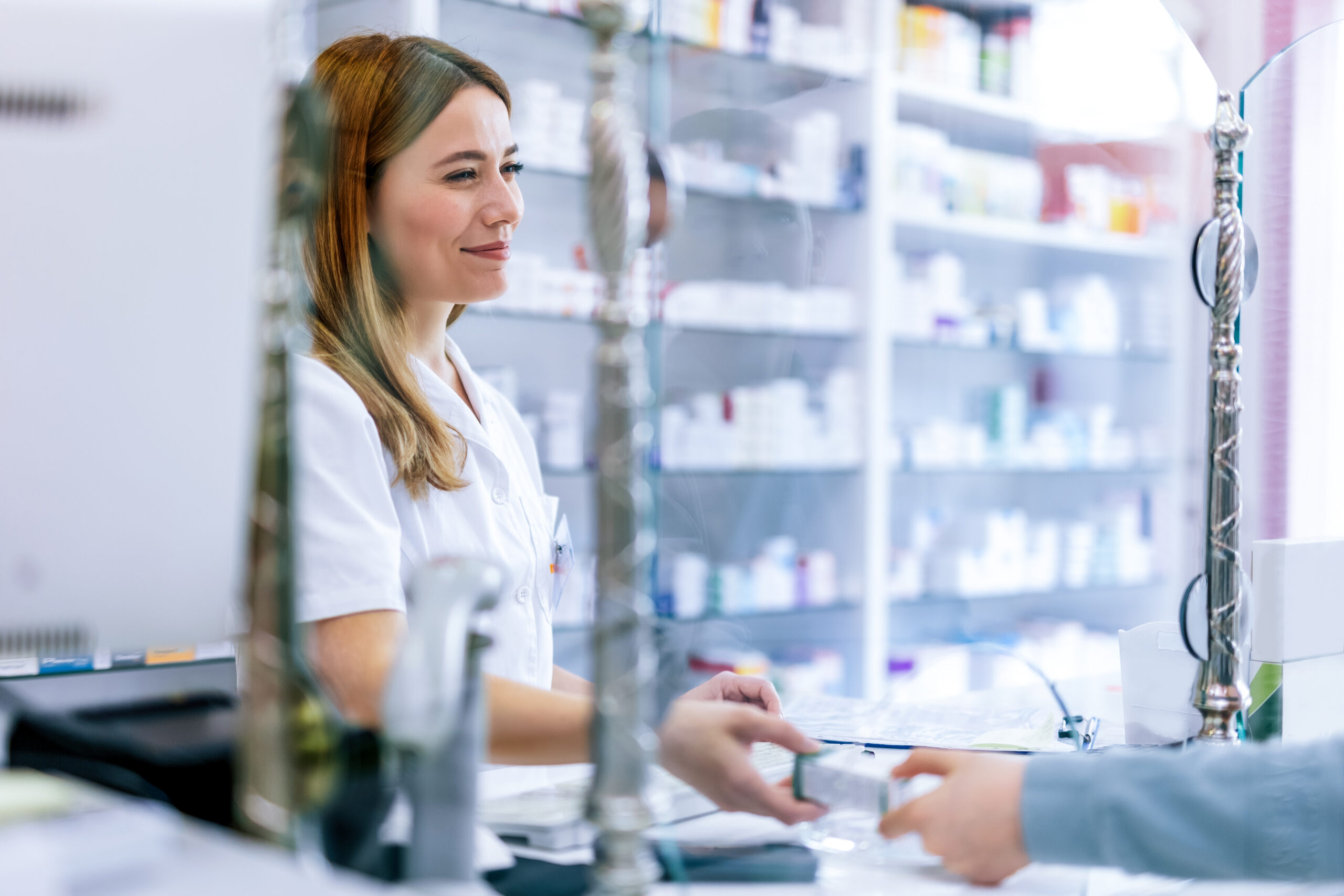 Woman pharmacist consulting customer at counter for prescription drugs or medicine at the pharmacy. Female doctor giving patient medical antibiotics at the pharmacy. pharmacy gpo